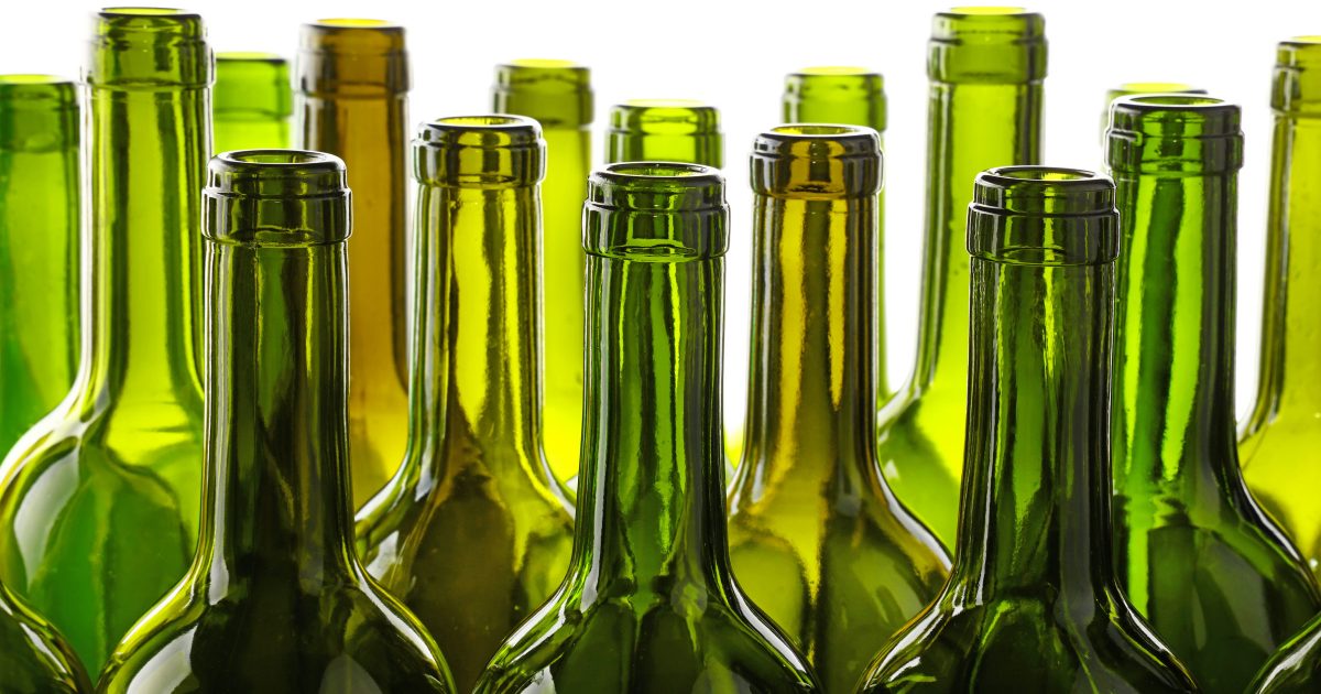 Empty green glass wine bottles isolated on white