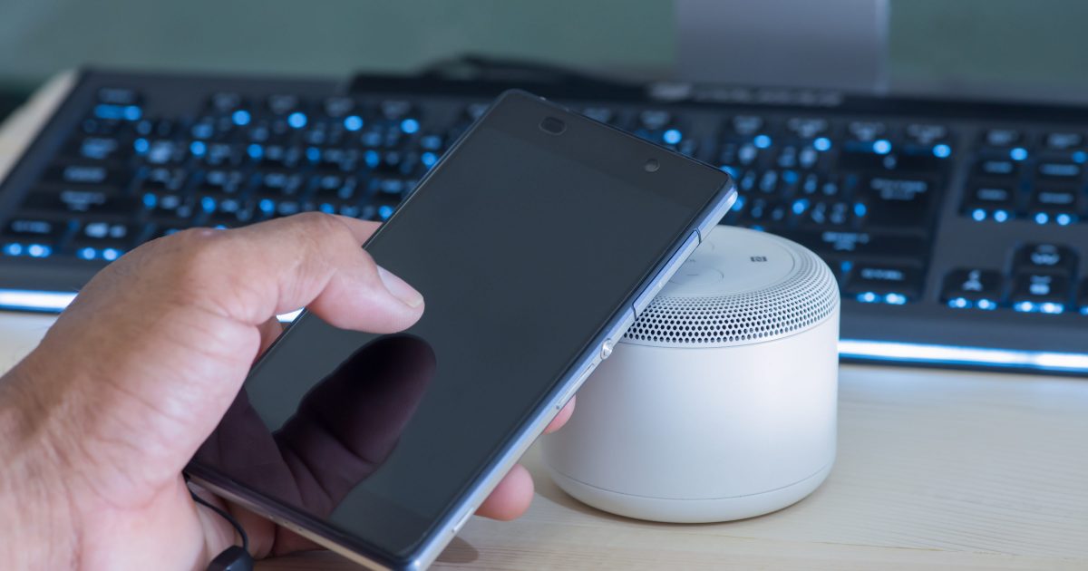 Smartphone and NFC speaker,Using NFC application to connect with wireless speaker.NFC (Near Field Communication),selective focus.