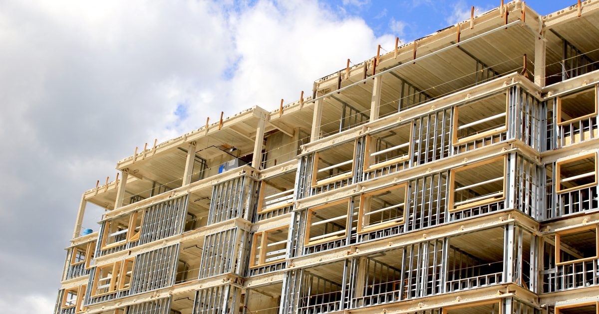 Construction site of residential building on blue sky background
