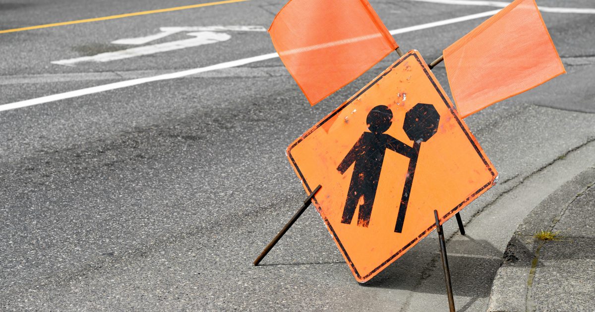 Construction flagger ahead sign