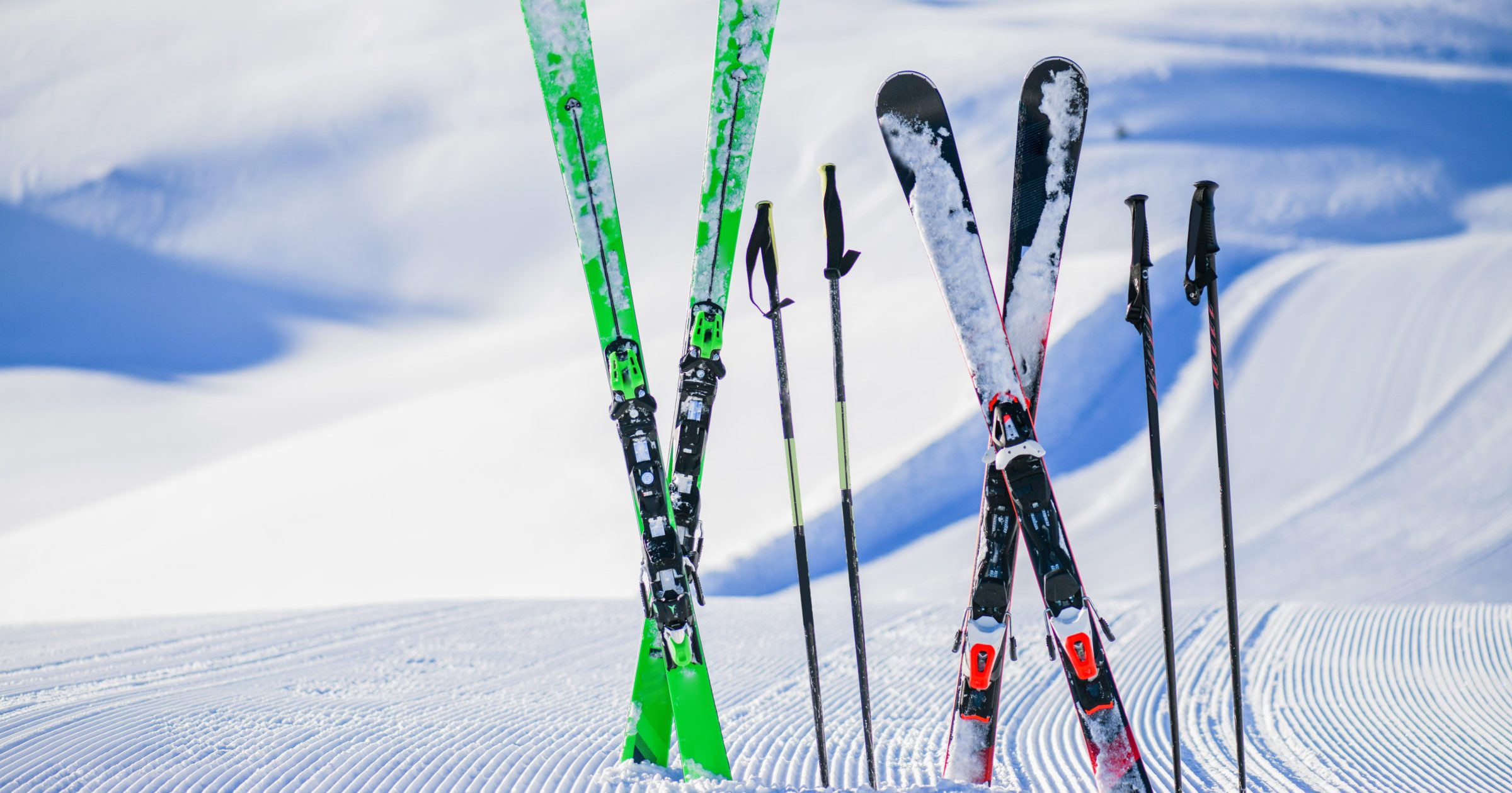 Skis in snow in winter season, mountains and ski items or equipments on the top in dolomites,