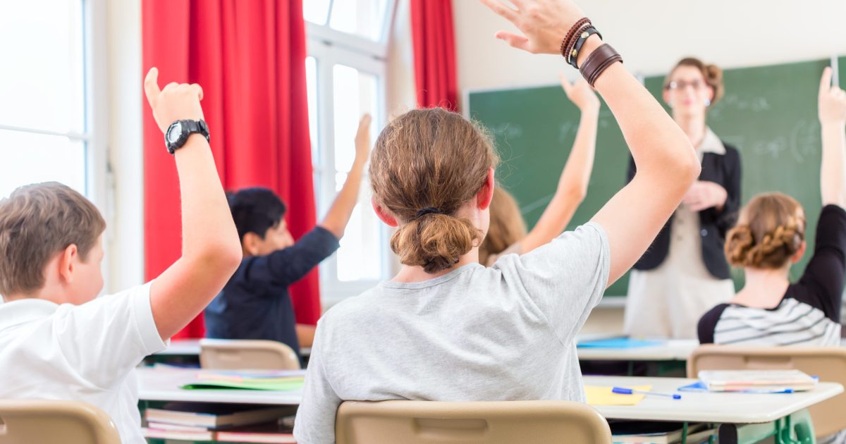 Teacher  educate or teaching a class of  pupils in school