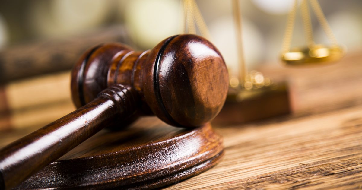 Golden scales of justice, books, Statue of Lady Justice. Owl and paragraph