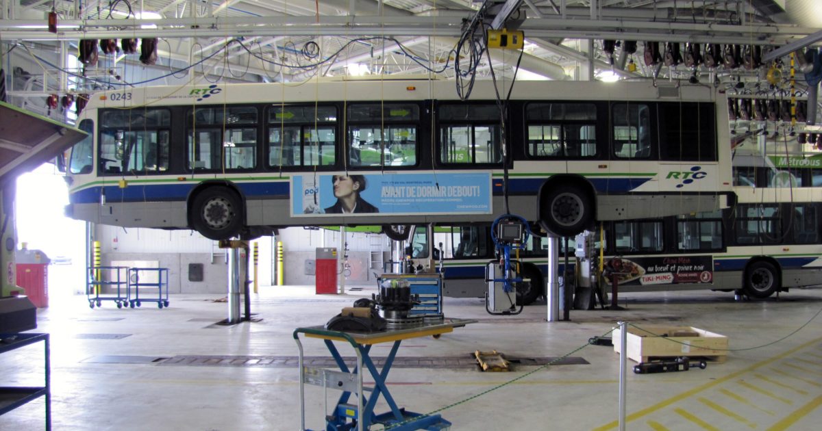 Un autobus du RTC levé sur deux vérins pour son entretien. Photo : Claude Boucher - CC.